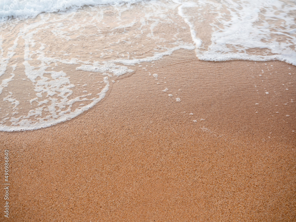 Clean sand beach background with blurred movement of splashing sea waves with copy space. summer sunset beach background. Clean sand beach background with blurred movement of splashing sea waves with copy space. summer sunset beach background.