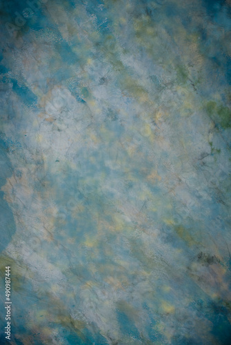 Canvas cloth or muslin photography studio background or backdrop. Classic painted strokes technique, stormy paintbrush strokes in shades of blue, green, light yellow and white