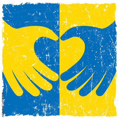 Ukrainian flag with hands forming heart shape. Symbol of support for Ukraine during Russian invasion.