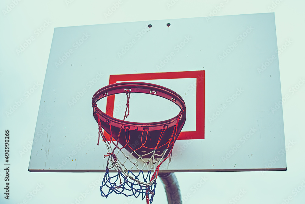 Low angle of basketball hoop with red white blue net