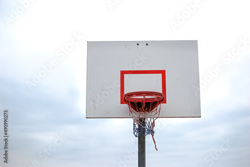 Low angle of basketball hoop with red white blue net