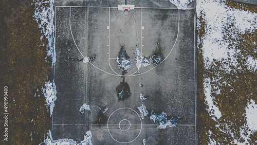 Snow covered park with basketball court photo