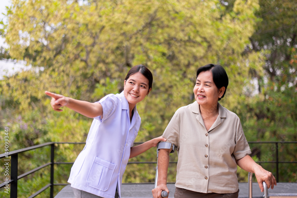 Physiotherapist take care senior woman hand holding crutch trying to walk,Physical therapy concept Physiotherapist take care senior woman hand holding crutch trying to walk,Physical therapy concept
