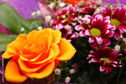 orange rose with pink chrysanthemums in a bouquet close-up