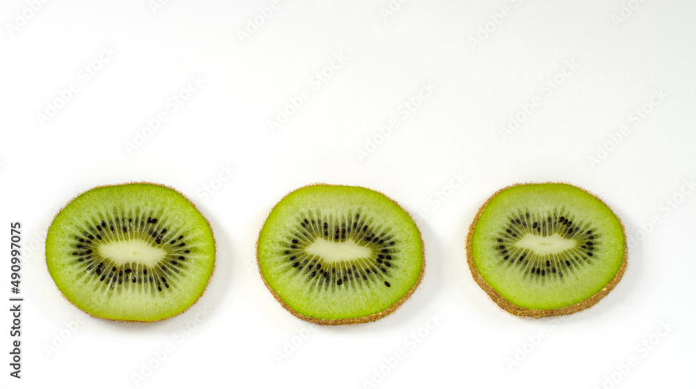 Fototapeta premium kiwi slices on a white surface, background, banner