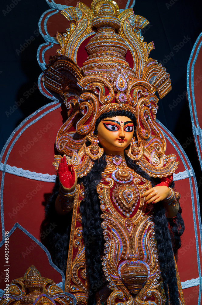 Naklejka premium Goddess Laxmi, Durga Puja festival at night. Shot under colored light at Howrah, West Bengal, India.