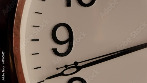 White clock face ticking stock footage. black numerals on white dial, time goes by on the clock. Clock close up