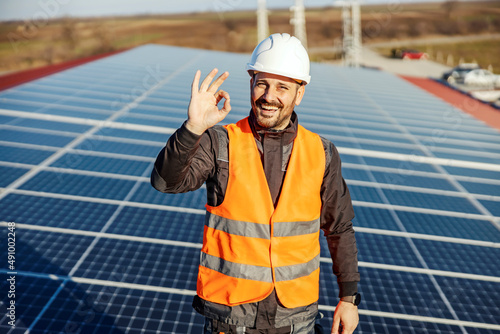 A worker gesturing with hand with okay sign for sustainable lifestyle. photo