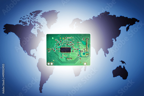 Electronic circuit board on  world map background. Concept of production of electronics microchip, motheboard, cpu. photo