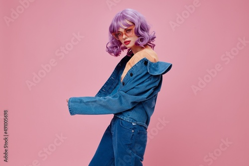 Positive young woman purple hair fashion glasses denim clothing color background unaltered