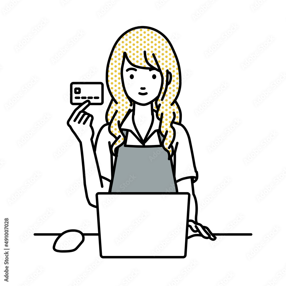 デスクで座ってPCを使いながらクレジットカードを手に持っているカフェ店員の女性
