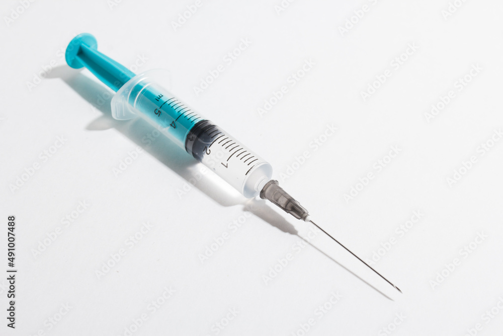 Medical syringe on a white background. A syringe for injection. The concept of health and beauty Medical syringe on a white background. A syringe for injection. The concept of health and beauty