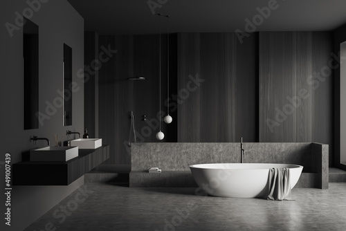 Front view on dark bathroom interior with bathtub  shower