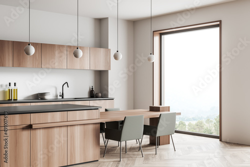 Kitchen interior with table and seats, shelves and panoramic window