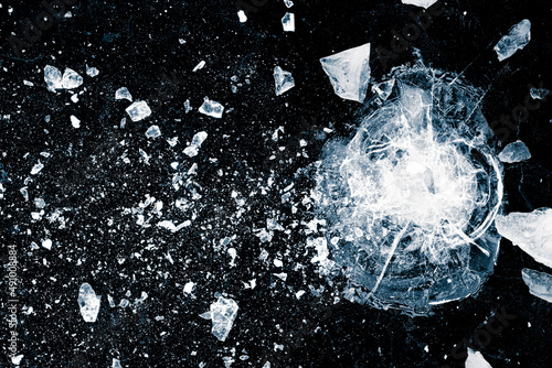 Cracked ice surface. Ice, crushed on black background. Pieces of crushed ice spread away. photo