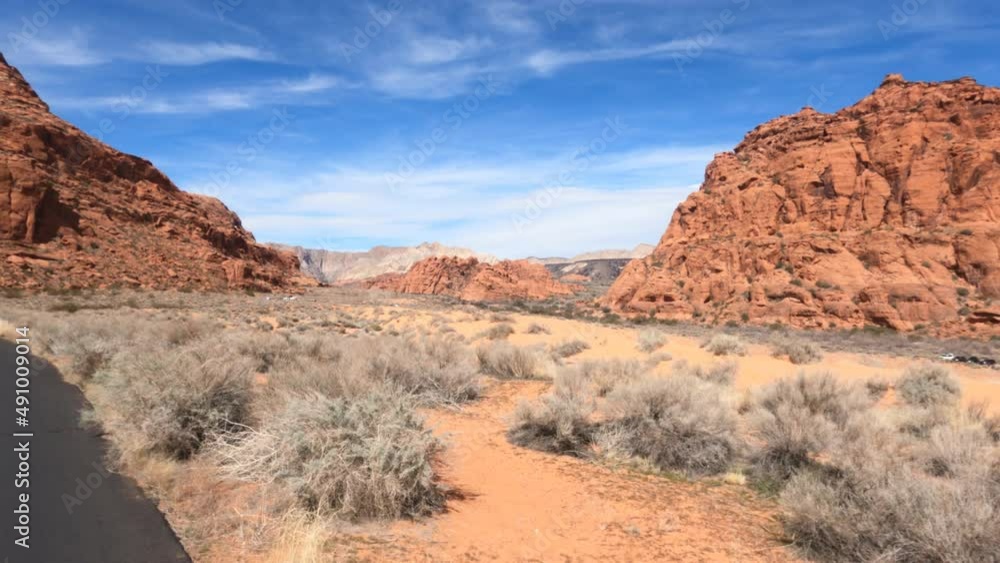 Riding bike trail desert landscape St George Utah. Bicycle trails in St George southern Utah desert and red rock landscape. Healthy Exercise on paths in mountains, valley and city. Electric bike. Riding bike trail desert landscape St George Utah. Bicycle trails in St George southern Utah desert and red rock landscape. Healthy Exercise on paths in mountains, valley and city. Electric bike.