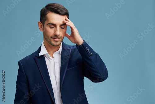 man holding his head blue suit hand gestures isolated background
