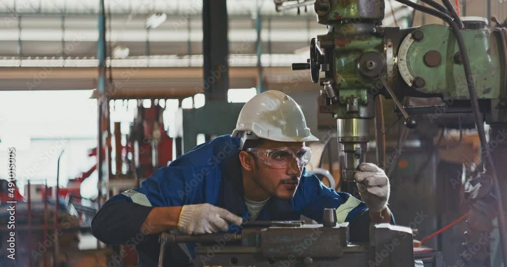 Heavy Industry Engineer/Worker Wearing Uniform, Glasses and Hard Hat in a Steel Factory Heavy Industry Engineer/Worker Wearing Uniform, Glasses and Hard Hat in a Steel Factory