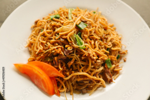 "yakisoba is traditional stir fried noodle japan, made from noodles, cabbage, vegetables and meat, seasoning with oyster sauce or yakisoba sauce. yakisoba served on plate" 