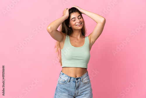 Young caucasian woman isolated on pink background laughing