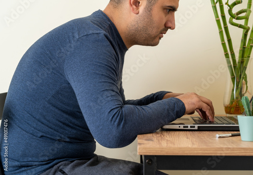 Side view photo of a man with scoliosis, hunched back posture, position defect, curvature or incorrect spine. Selective focus.