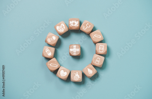 Wooden block cube which print screen health care and medical icons for healthy and wellness concept.