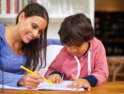 Learning with love. Shot of a mother helping her son with his homework.