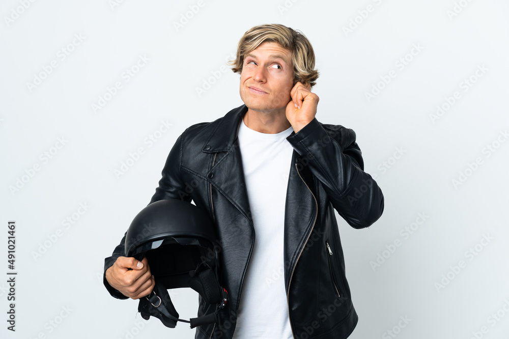 Naklejka premium English man holding a motorcycle helmet frustrated and covering ears