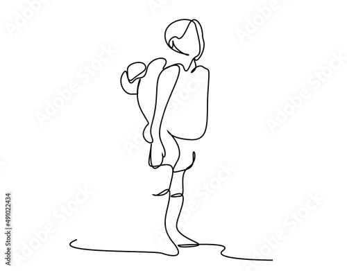 poor hardworking determined young boy carrying his little baby brother on his back