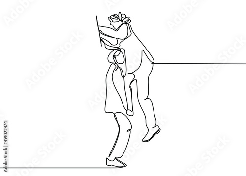 a business person who makes his hand like a stair step helps his other friend to overcome the obstacle