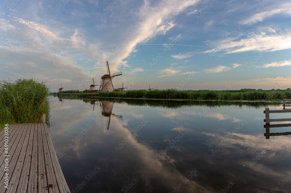 Dutch traditional windmill reflection and platform by the water at Kinderdijk Netherlands