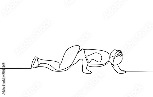 A sporty flexible man moving stealthily crawling on the floor