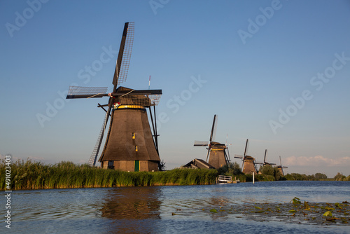 Fototapeta Naklejka Na Ścianę i Meble -  Traditional Dutch windmills by the water at Kinderdijk