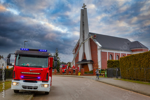 Fire brigade called to damaged church roof after a storm. Poland photo