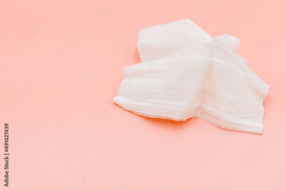 Top view flat lay cleansing wet wipes to remove makeup and clean the skin on orange background with copy space, White wet tissue paper healthcare and hygiene concept. Top view flat lay cleansing wet wipes to remove makeup and clean the skin on orange background with copy space, White wet tissue paper healthcare and hygiene concept.
