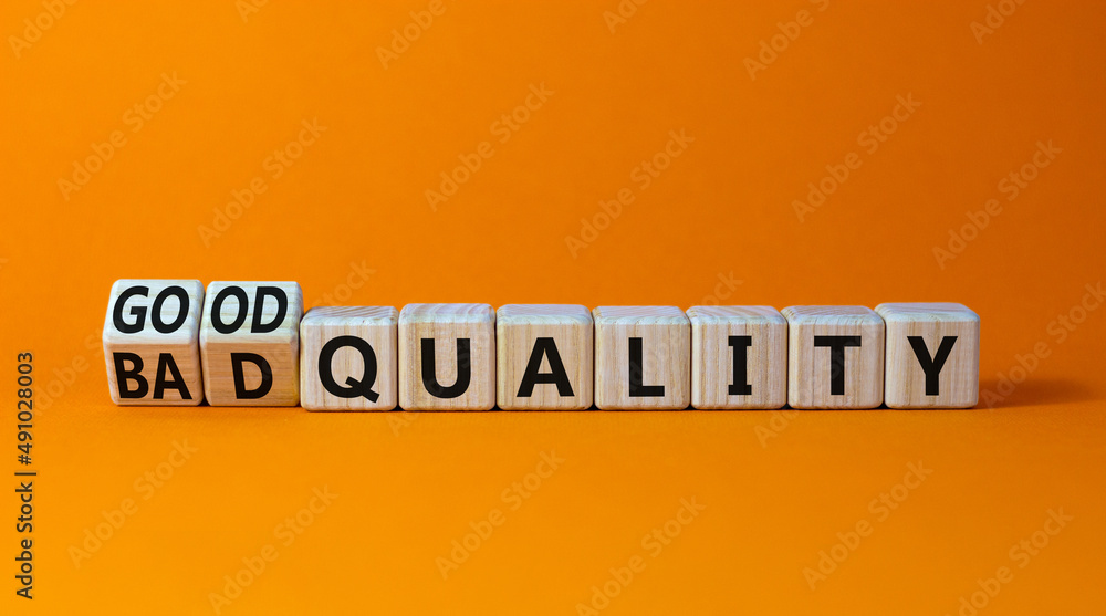 Good or bad quality symbol. Turned wooden cubes and changed words bad quality to good quality. Beautiful orange table orange background. Business good or bad quality concept, copy space. Good or bad quality symbol. Turned wooden cubes and changed words bad quality to good quality. Beautiful orange table orange background. Business good or bad quality concept, copy space.