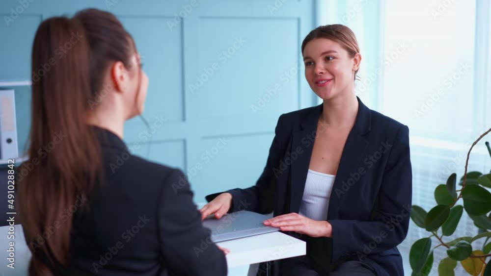 Job interview , Business, career and placement concept. Young blonde woman smiling and holding resume, while sitting in front of candidate during corporate meeting or job interview. Business deal Job interview , Business, career and placement concept. Young blonde woman smiling and holding resume, while sitting in front of candidate during corporate meeting or job interview. Business deal