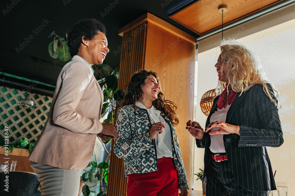 Three diverse businesswomen at cafe socializing Three diverse businesswomen at cafe socializing