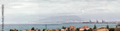 Panoramic view of the port and the western area of the city of Malaga  Spain on a cloudy winter day with the sea moving