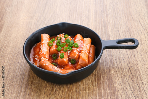 Tteokbokki or Topokki , stir fried rice cake stick, popular Korean street food with spicy gochujang sauce and sesame seed. 