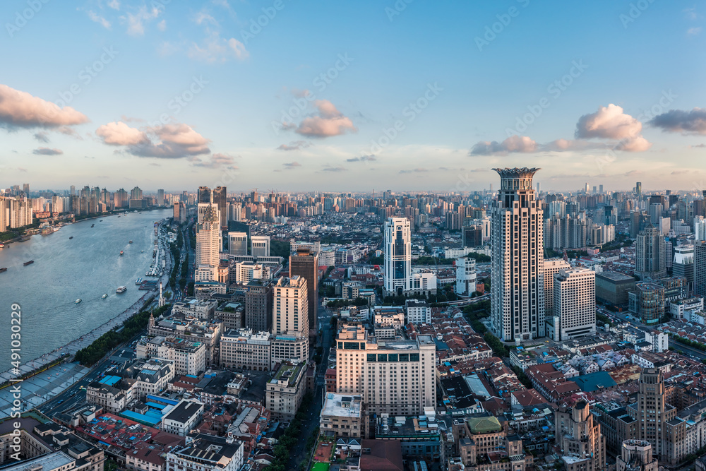 Aerial view of city skyline and modern commercial buildings in Shanghai at sunset, China.