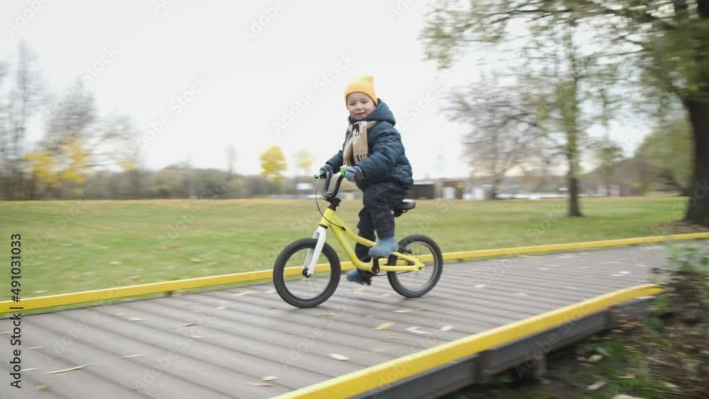Fall from bike. Child on bicycle riding along path in city park and falling down. Sport children's injuries. Joint injury during outdoor activities. Accident with bicycle. Fall from bike. Child on bicycle riding along path in city park and falling down. Sport children's injuries. Joint injury during outdoor activities. Accident with bicycle.