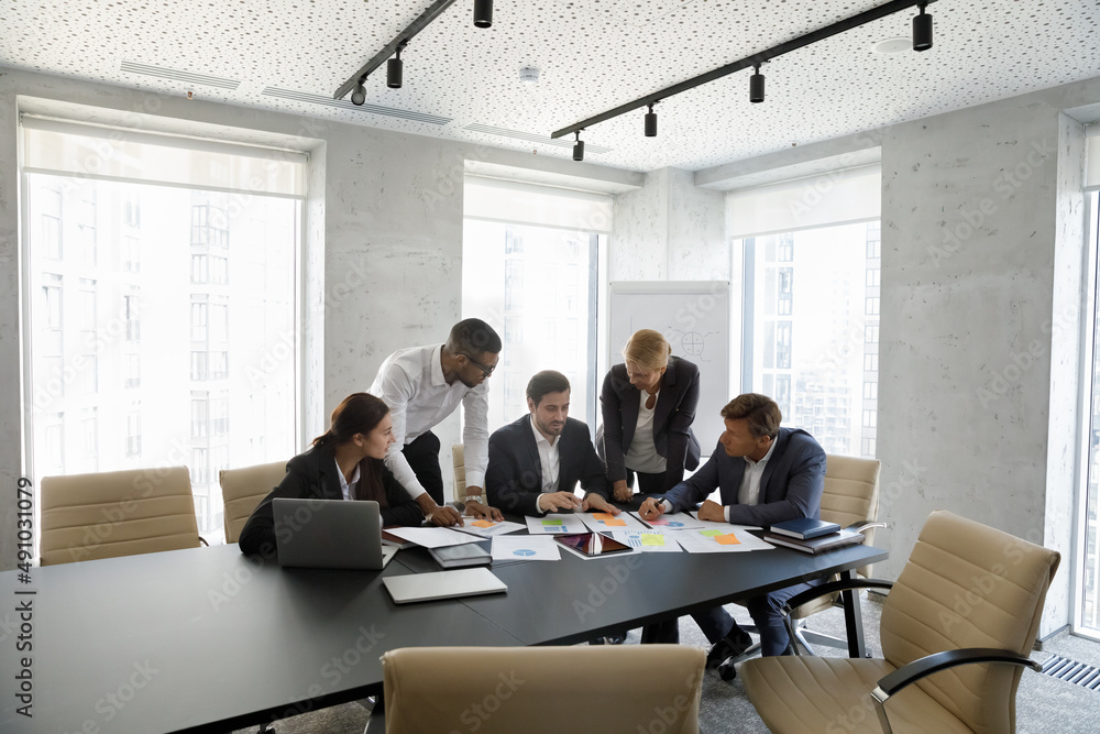 custom made wallpaper toronto digitalConcentrated successful happy diverse colleagues analyzing financial paper documents at briefing meeting, developing corporate growth strategy or discussing marketing research results in modern office