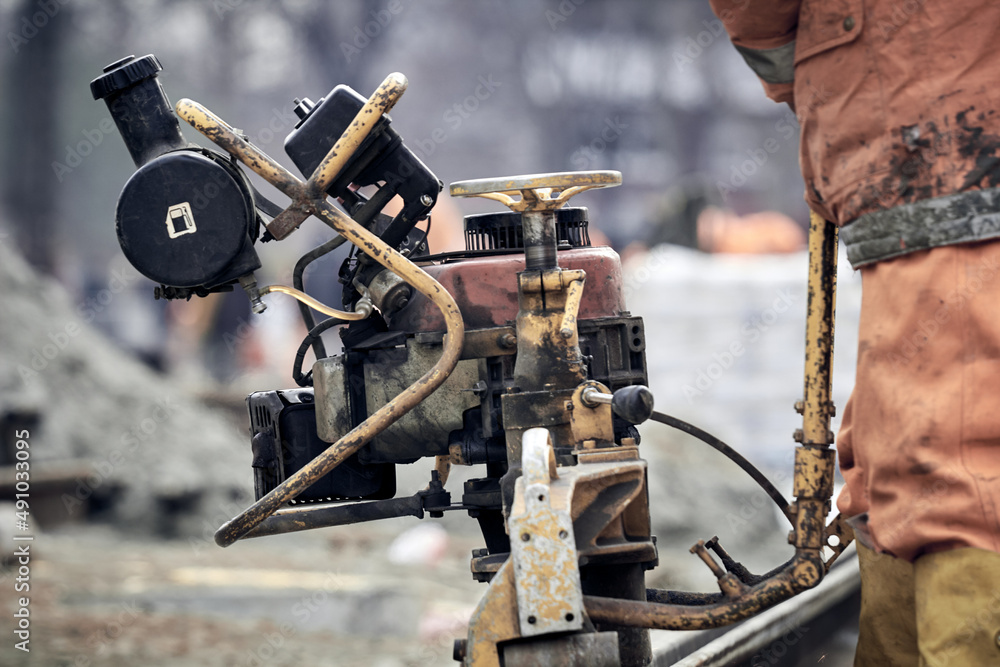 Construction worker using machine for steel train tracks. Construction worker using machine for steel train tracks.