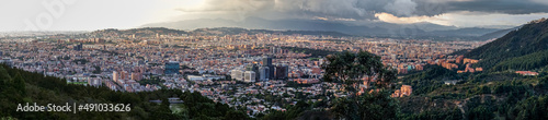 Panorama of the high plateau with the Colombian capital Bogota with dramatic cloudy sky and sunlight 