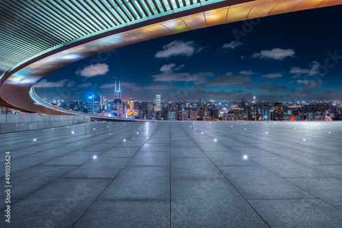 Empty square floor and city skyline with buildings in Shanghai at night  China.