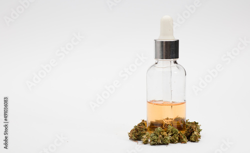 CBD (Cannabidiol) oil with bottle and dropper with buds. White background. CBD isolated hemp oil. THC-free