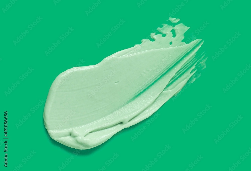 Green clay or mud masc foam smudge swatch texture on olive green background Green clay or mud masc foam smudge swatch texture on olive green background