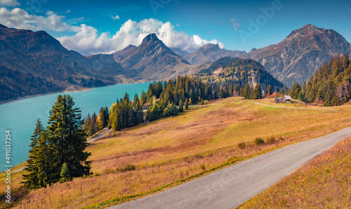 Stunning morning view of Roselend lake/Lac de Roselend. Sunny autumn scene of Auvergne-Rhone-Alpes, France, Europe. Traveling concept background.