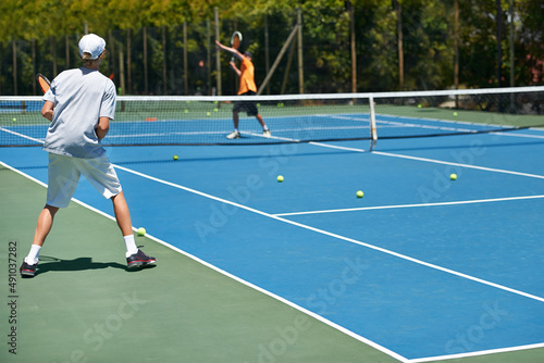 Hell be a start one day. Shot of a young boy playing tennis on a sunny day. © Marine Gastineau/peopleimages.com